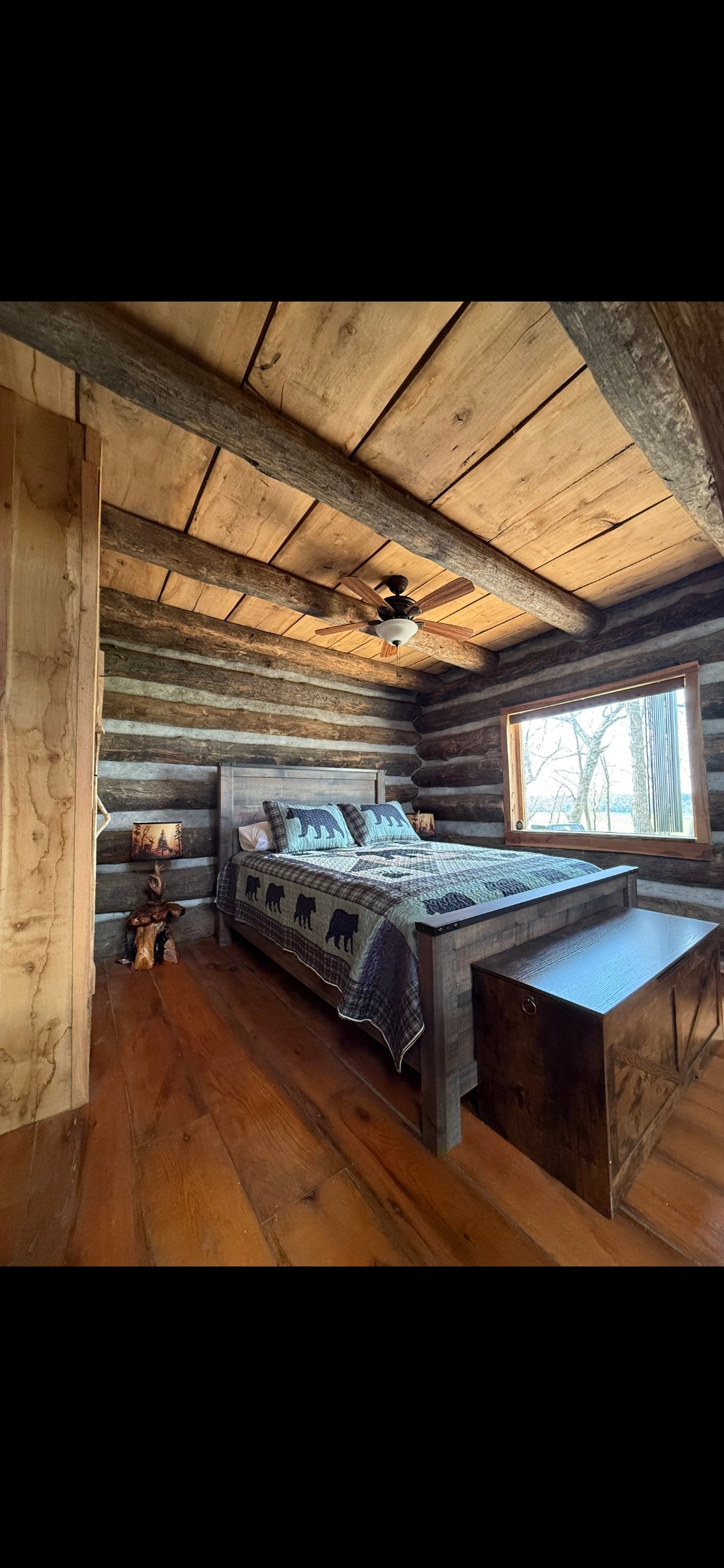 Cozy cabin bedroom with rustic wood beams and warm lighting